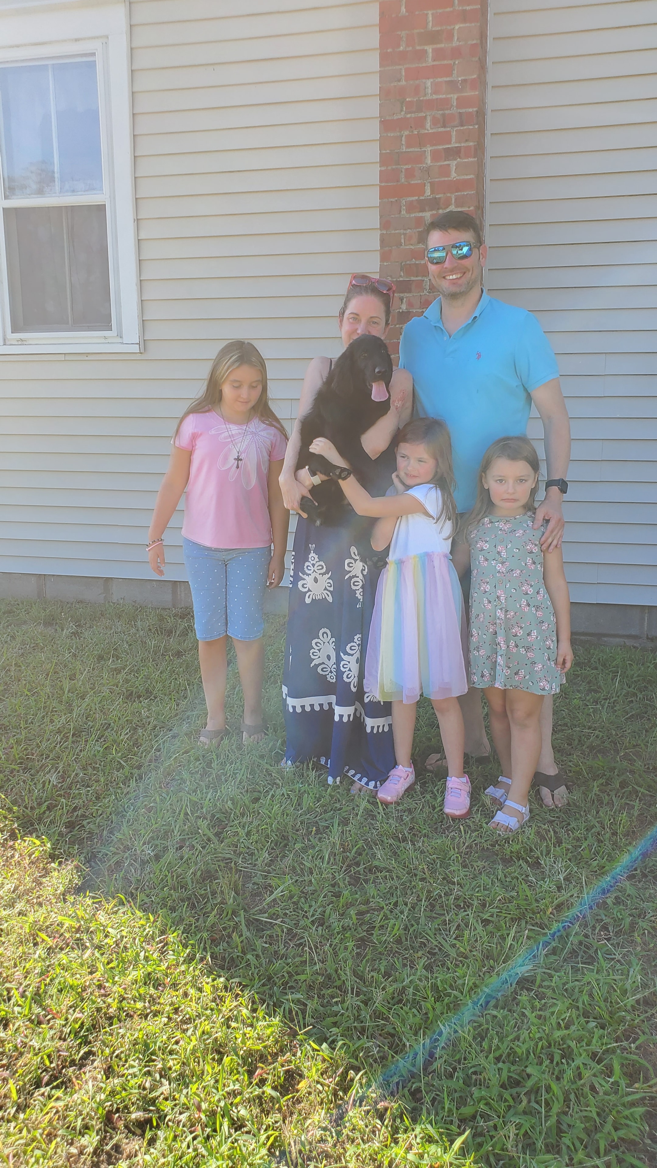 A Happy Family picking up their Argon's puppy