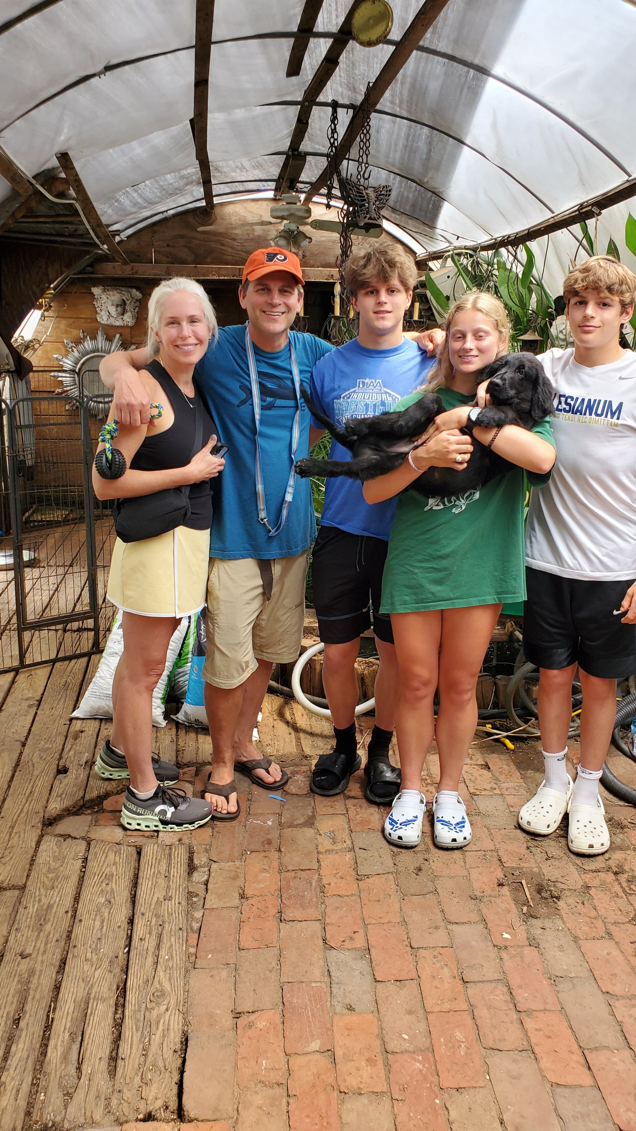 A Happy Family picking up their Argon's puppy