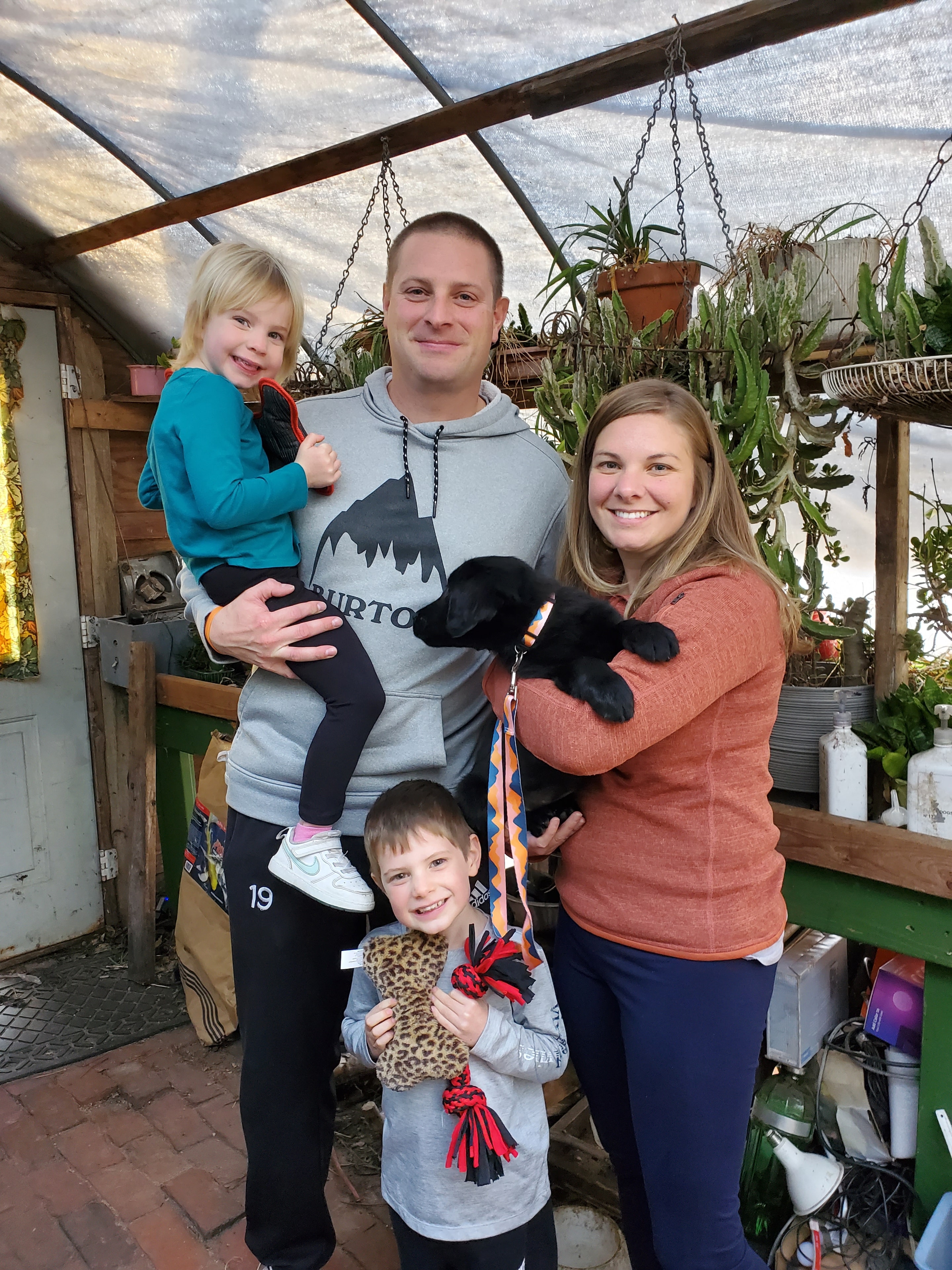 A Happy Family picking up their Argon's puppy