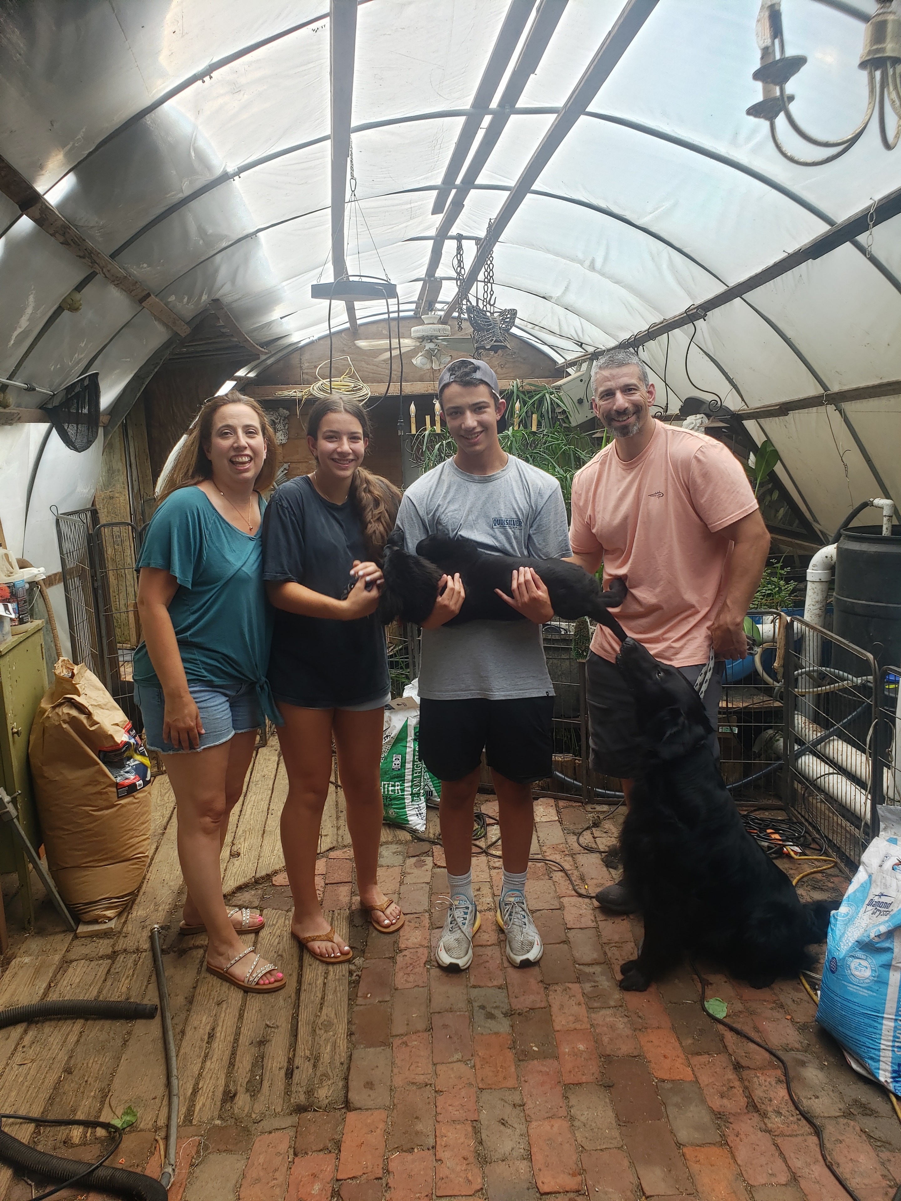 Happy family with new puppy on pickup day